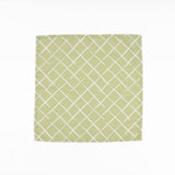 Light green cloth dinner napkins featuring a delicate white lattice pattern for elegant table settings.
