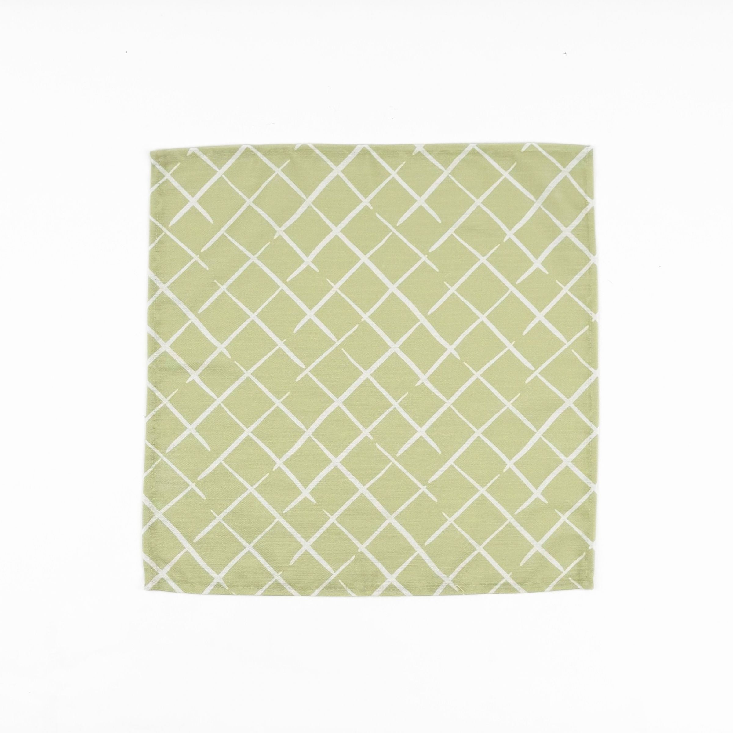 Light green cloth dinner napkins featuring a delicate white lattice pattern for elegant table settings.