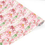 Whimsical Christmas gift wrap featuring festive giraffes, monkeys, zebras, and swans against playful pink stripes.