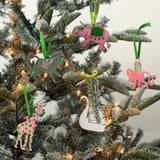 Hand-painted animal Christmas ornaments featuring a zebra, elephant, monkey, giraffe, and swan in festive colors.