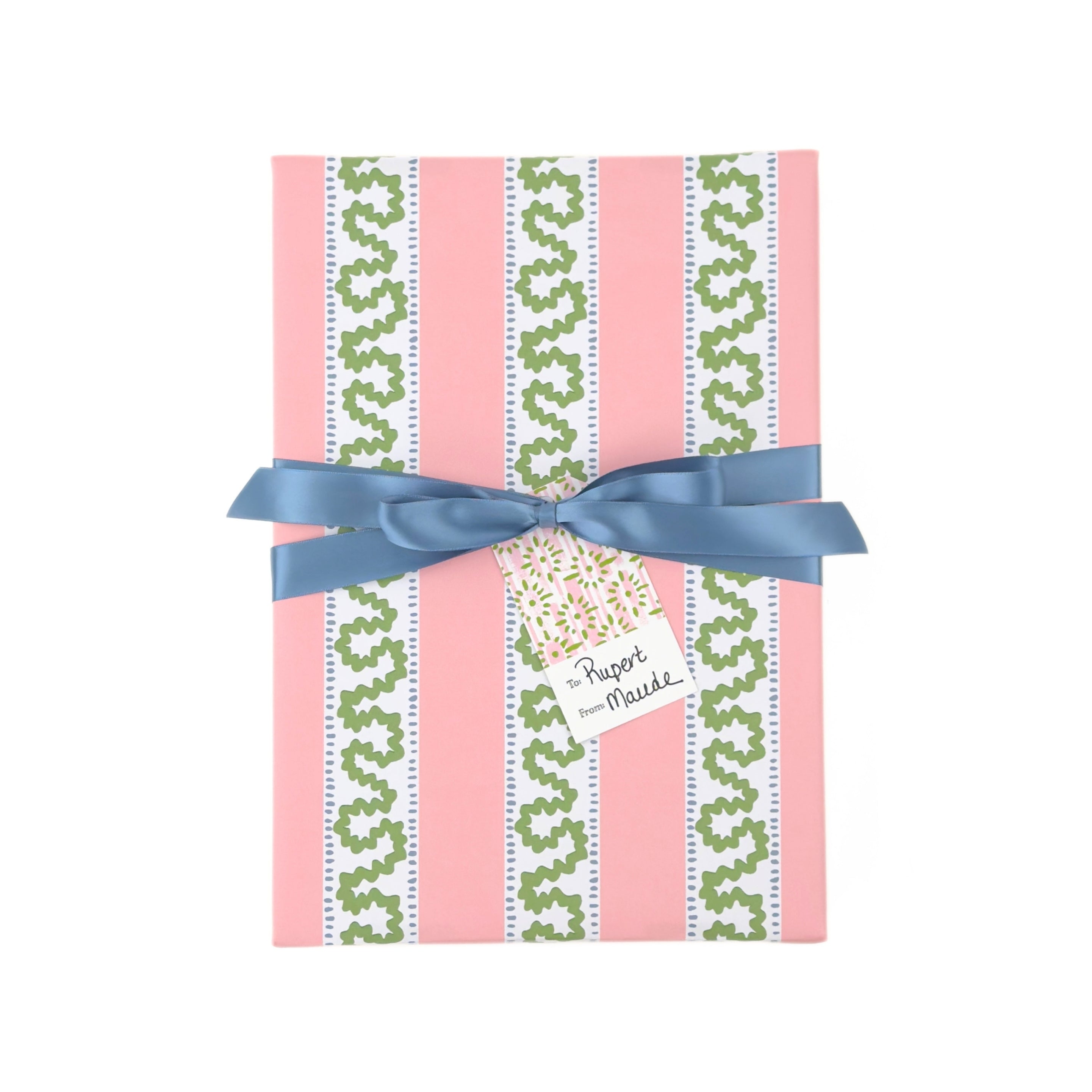 Front view of a present wrapped in pink and green Christmas wrapping paper with red ribbon and a paper tag