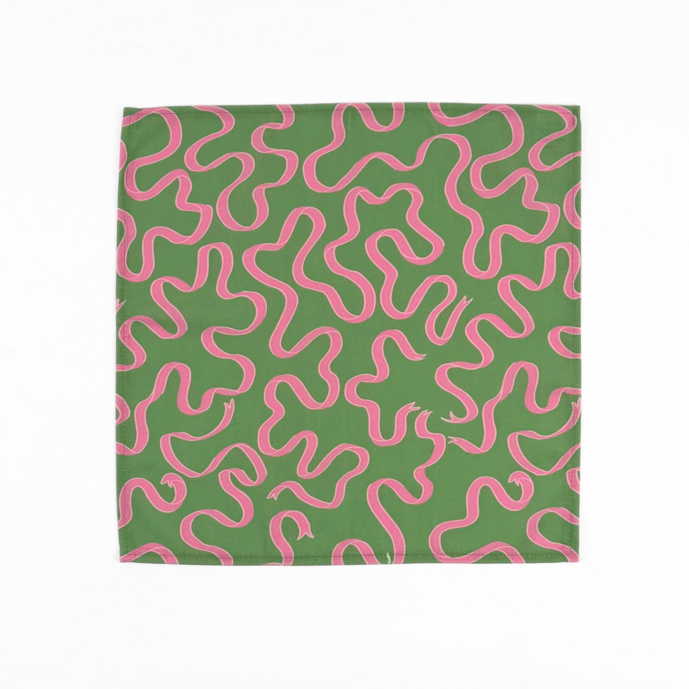 Green cloth dinner napkins featuring playful pink swirling ribbon patterns, perfect for colorful table settings.