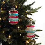 Patriotic tinsel glass ornaments featuring shimmering red, blue, and silver stripes with festive metallic finishes.