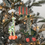 Wooden animal toy Christmas ornaments featuring colorful camel, elephant, and giraffe designs with decorative wheels.