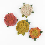4 Charming felt flower ornaments featuring colorful layered petals, green leaves, delicate embroidery, and sparkling sequin accents.