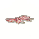 Red and white striped bow-shaped tray with gold edging displayed on a white background.