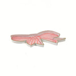 Flat view hand-painted tole tray featuring a delicate pink bow with white stripes and elegant gold trim on a white background