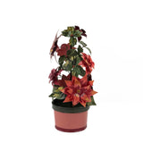 A large metal handpainted Christmas candle holder featuring red poinsettia flowers and green holly leaves with a pink base. 