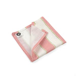 Folded Pink and white striped cloth dinner napkins featuring delicate green dotted accents for elegant tablescapes.