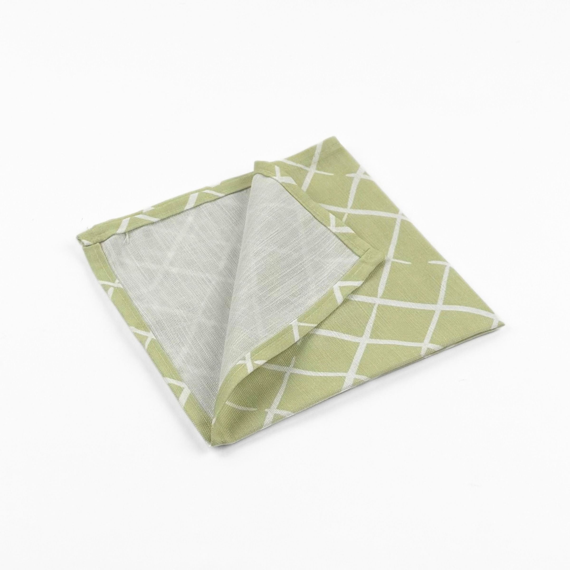 Folded Light green cloth dinner napkins featuring a delicate white lattice pattern for elegant table settings.