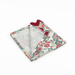 Folded Cloth dinner napkins featuring red and green Chinese dragon floral prints with burgundy ric rac trim.