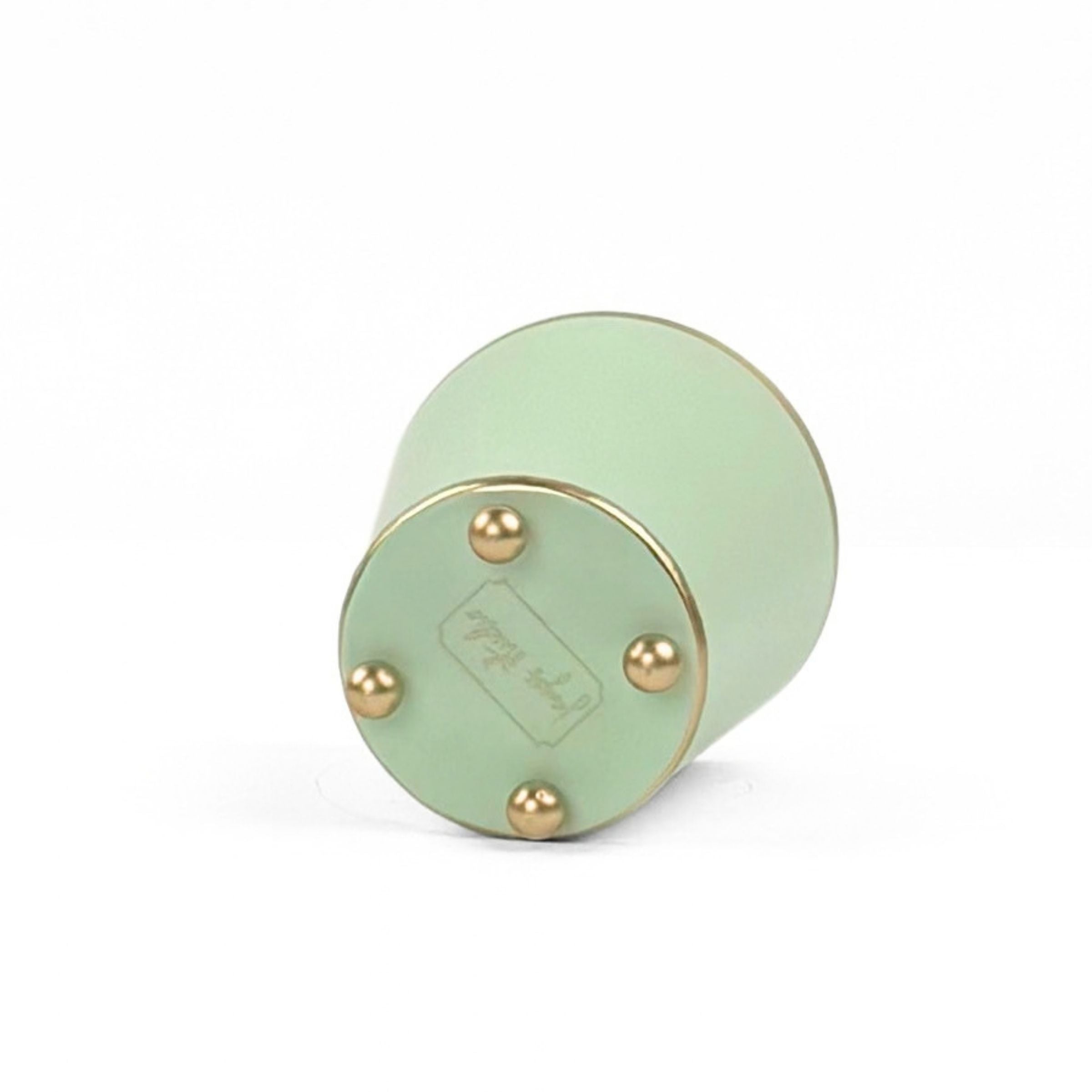 A bright Light green large tole metal cachepot bottom with four small gold-tone studs, shown on a white background.