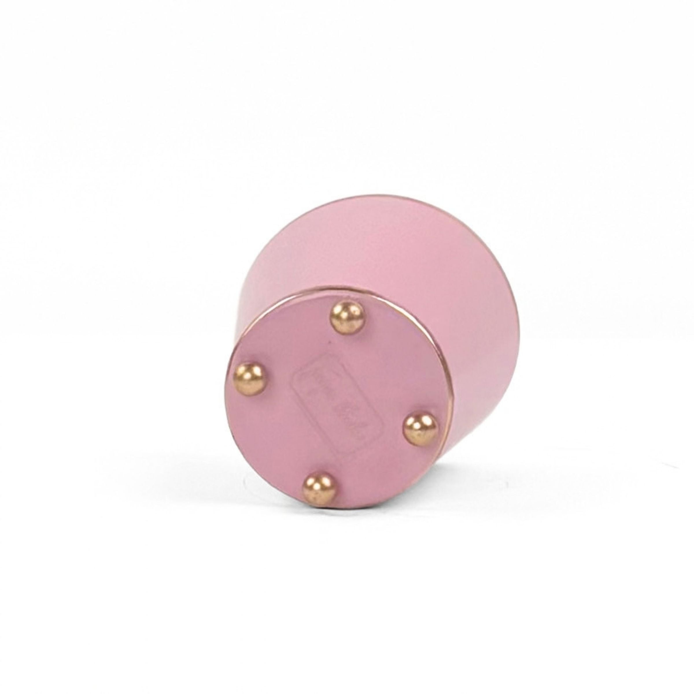 A bright light pink small tole metal cachepot bottom with four small gold-tone studs, shown on a white background.