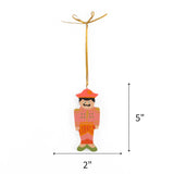 Pink hand painted wooden nutcracker Christmas ornament on a white background with dimension arrows indicating 5" by 2"