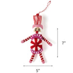 Pink and red felt nutcracker candy ornament featuring striped details, measuring 7" by 5"