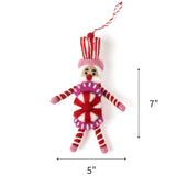 Pink and red felt nutcracker candy ornament featuring striped details, measuring 7" by 5"