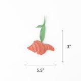 Felt pink and orange shell Christmas ornament featuring white accents, measuring 3" by 5.5"