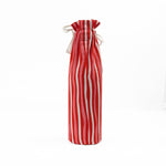 back of red and white striped wine bag with a “Santa, I have been goodish” label on the front