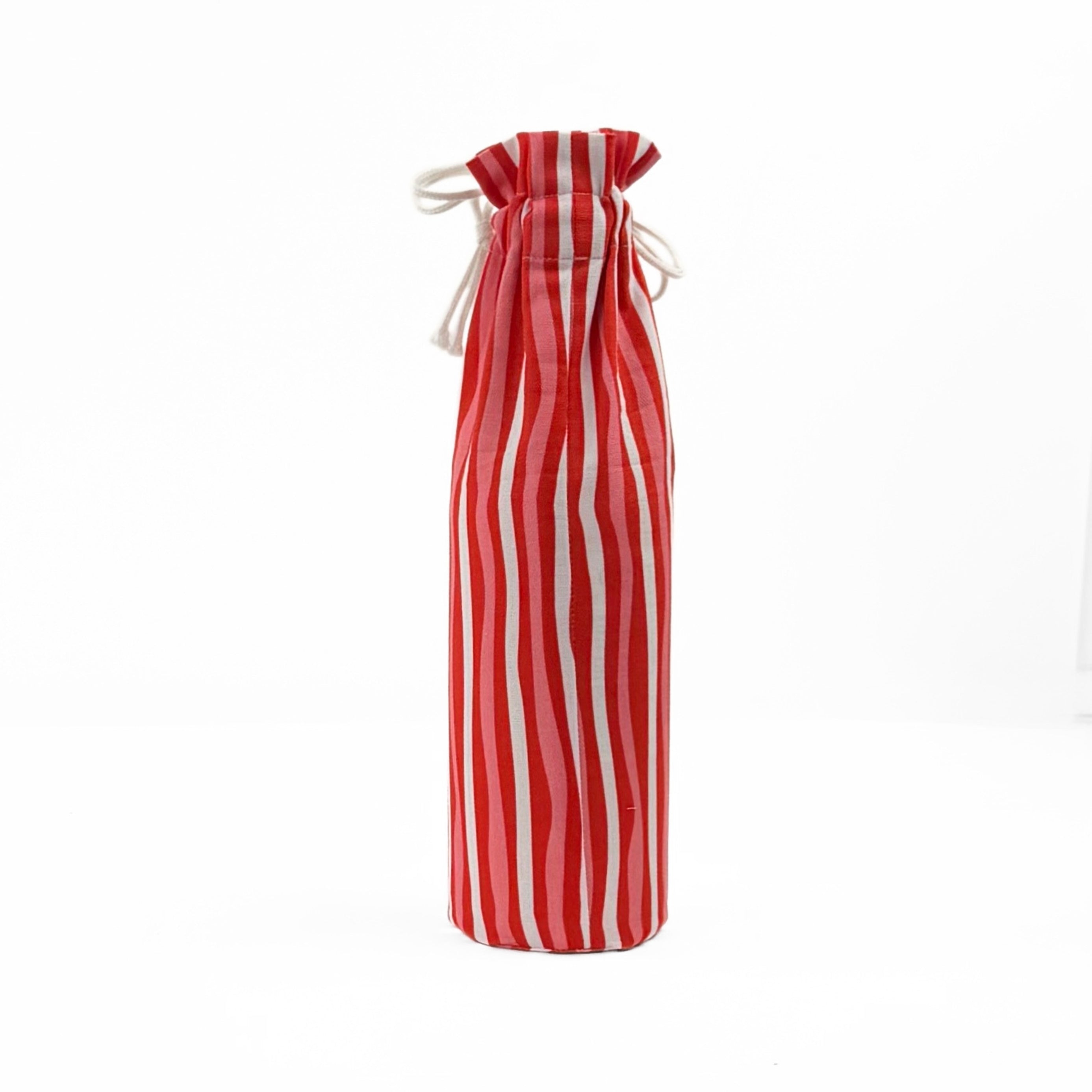 back of red and white striped wine bag with a “Santa, I have been goodish” label on the front