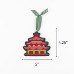 Felt chinoiserie pagoda Christmas ornament featuring pink, red, and green details, measuring 4.25" by 5"