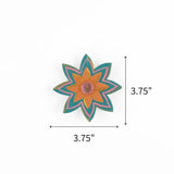 Blue jeweled flower Christmas ornament featuring orange petals and pink accents, measuring 3.75" by 3.75"