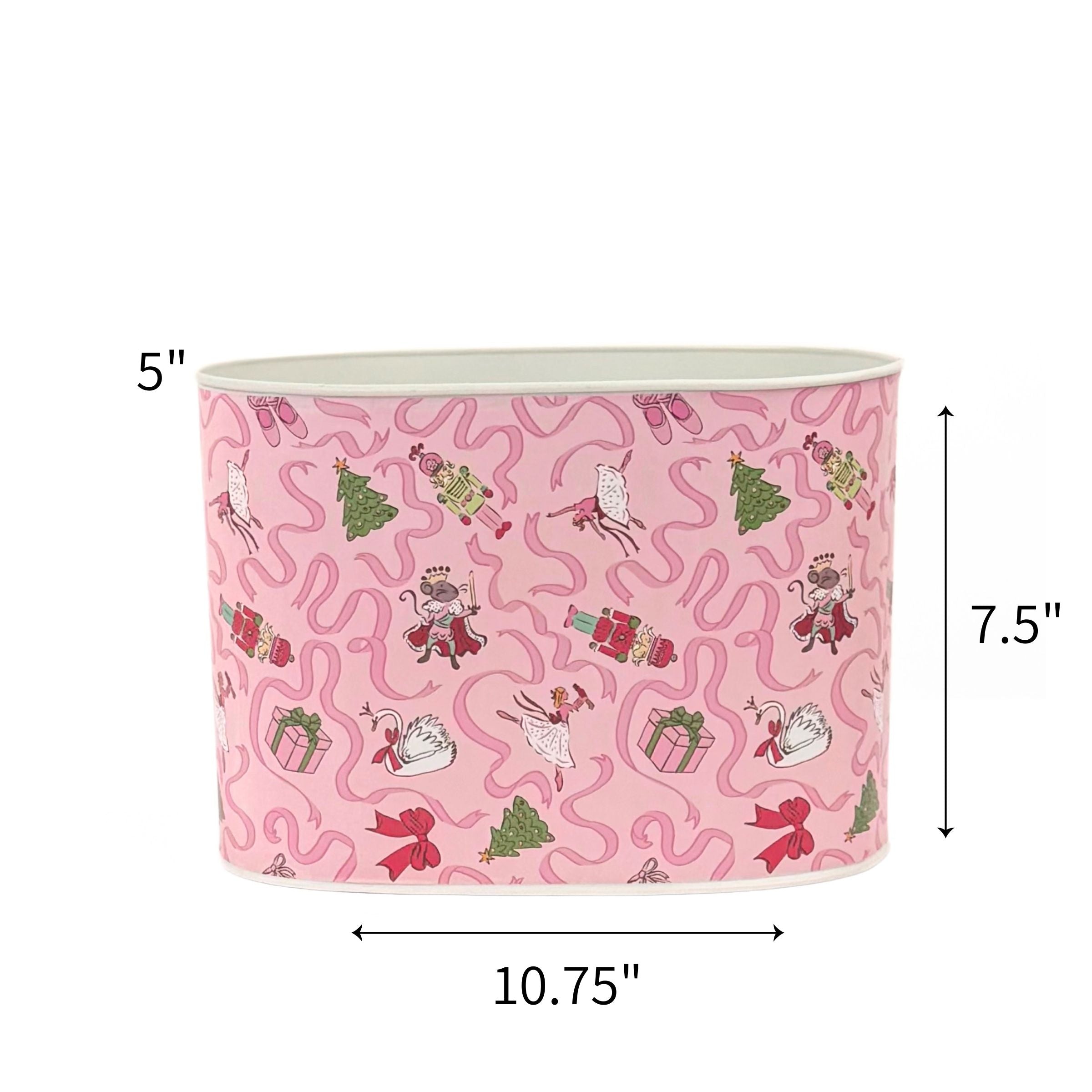 Large Festive pink Christmas caddy featuring nutcrackers, swans, Christmas trees, gifts, and whimsical ribbon patterns with dimensions of 5" by 7.5" by 10.75"