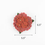 Pink felt flower ornament featuring layered petals, green leaves, and gold sequins, measuring 6.5" by 5.5"