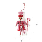 Pink and red felt nutcracker ornament holding a striped candy cane, measuring 7" by 5"