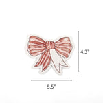 Elegant red bow place cards featuring delicate white stripes and personalized names for festive table settings with dimension indicating 5.5" by 4.3"