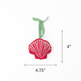Felt pink scallop shell Christmas ornament featuring white stripes, measuring 4" by 4.75"