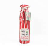 red and white striped wine bag with a “Santa, I have been goodish” label on the front