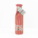 pink and green striped wine bag with “Let’s get jolly!” printed on the front