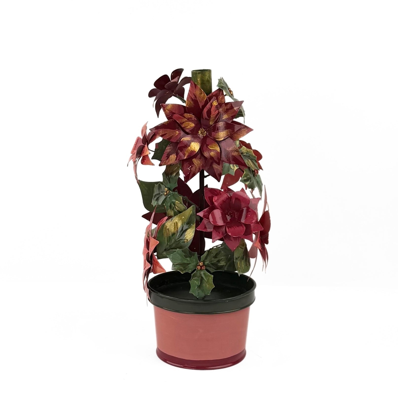 A large metal handpainted Christmas candle holder featuring red poinsettia flowers and green holly leaves with a pink base. 