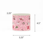 Small Festive pink Christmas caddy featuring nutcrackers, swans, Christmas trees, gifts, and whimsical ribbon patterns with dimensions of 2.25" by 4.5" by 5.25"