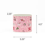 Small Festive pink Christmas caddy featuring nutcrackers, swans, Christmas trees, gifts, and whimsical ribbon patterns with dimensions of 2.25" by 4.5" by 5.25"