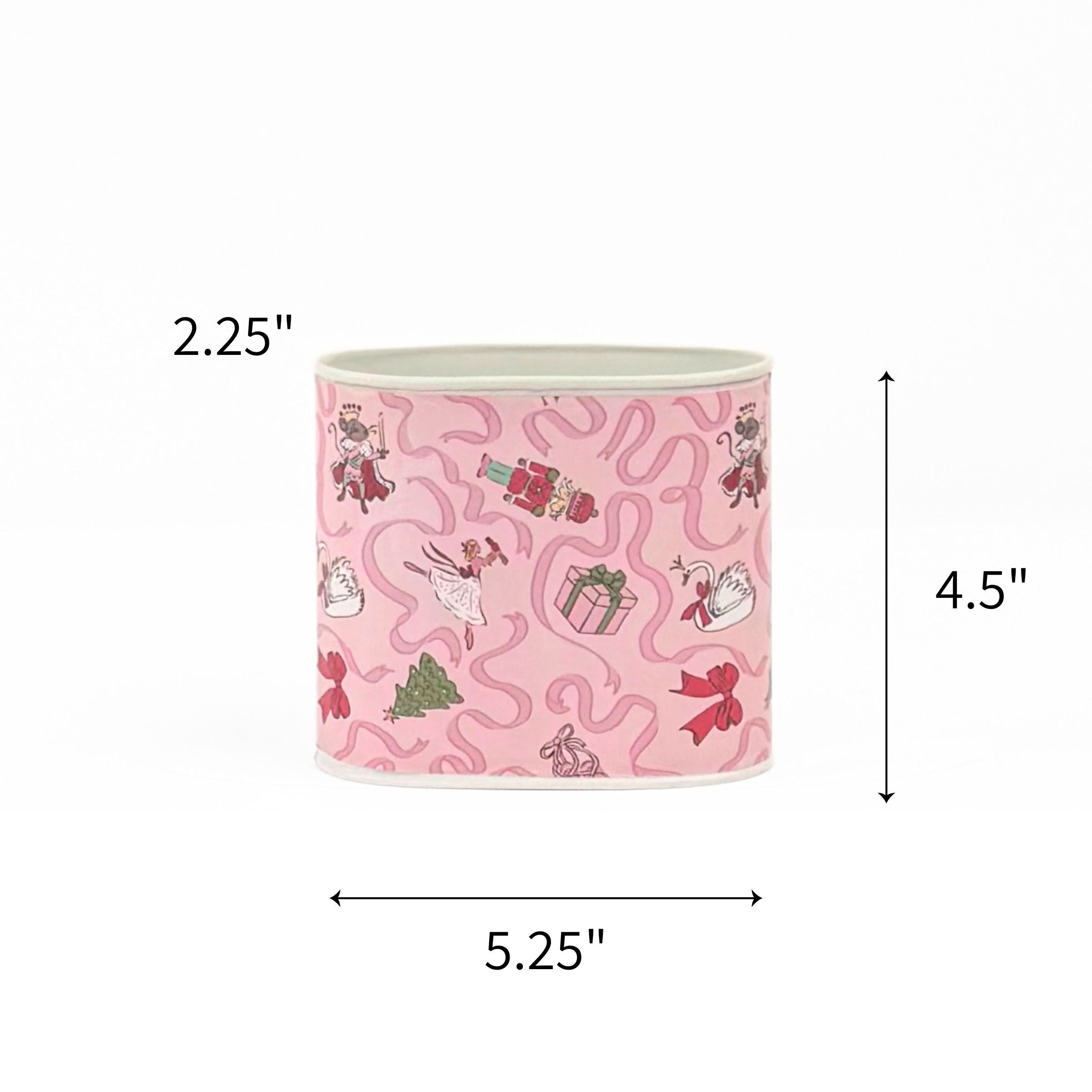 Small Festive pink Christmas caddy featuring nutcrackers, swans, Christmas trees, gifts, and whimsical ribbon patterns with dimensions of 2.25" by 4.5" by 5.25"