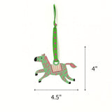 Hand-painted zebra Christmas ornament featuring green and pink stripes, measuring 4" by 4.5"