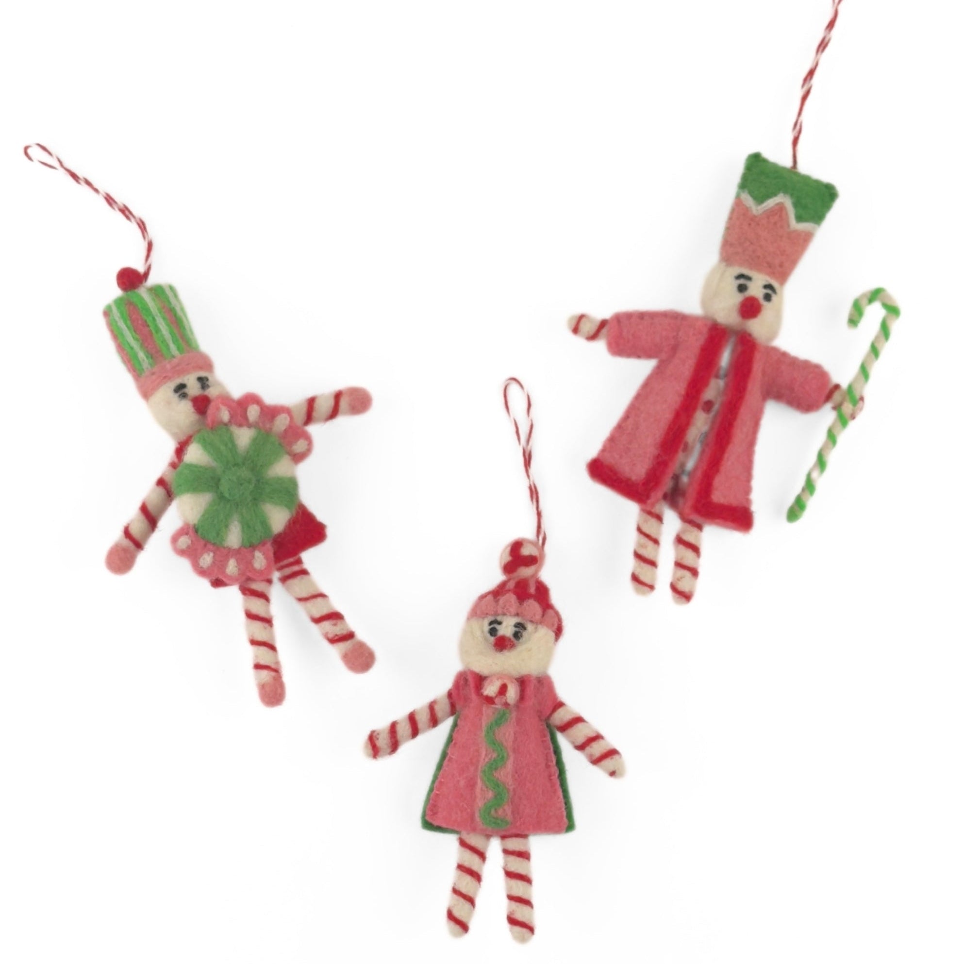 Three Pink and green felt nutcracker Christmas ornaments featuring playful candy-inspired details and festive striped accents.