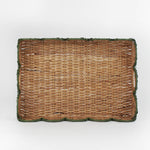 Rattan tray with scalloped edge and green trim on a white background