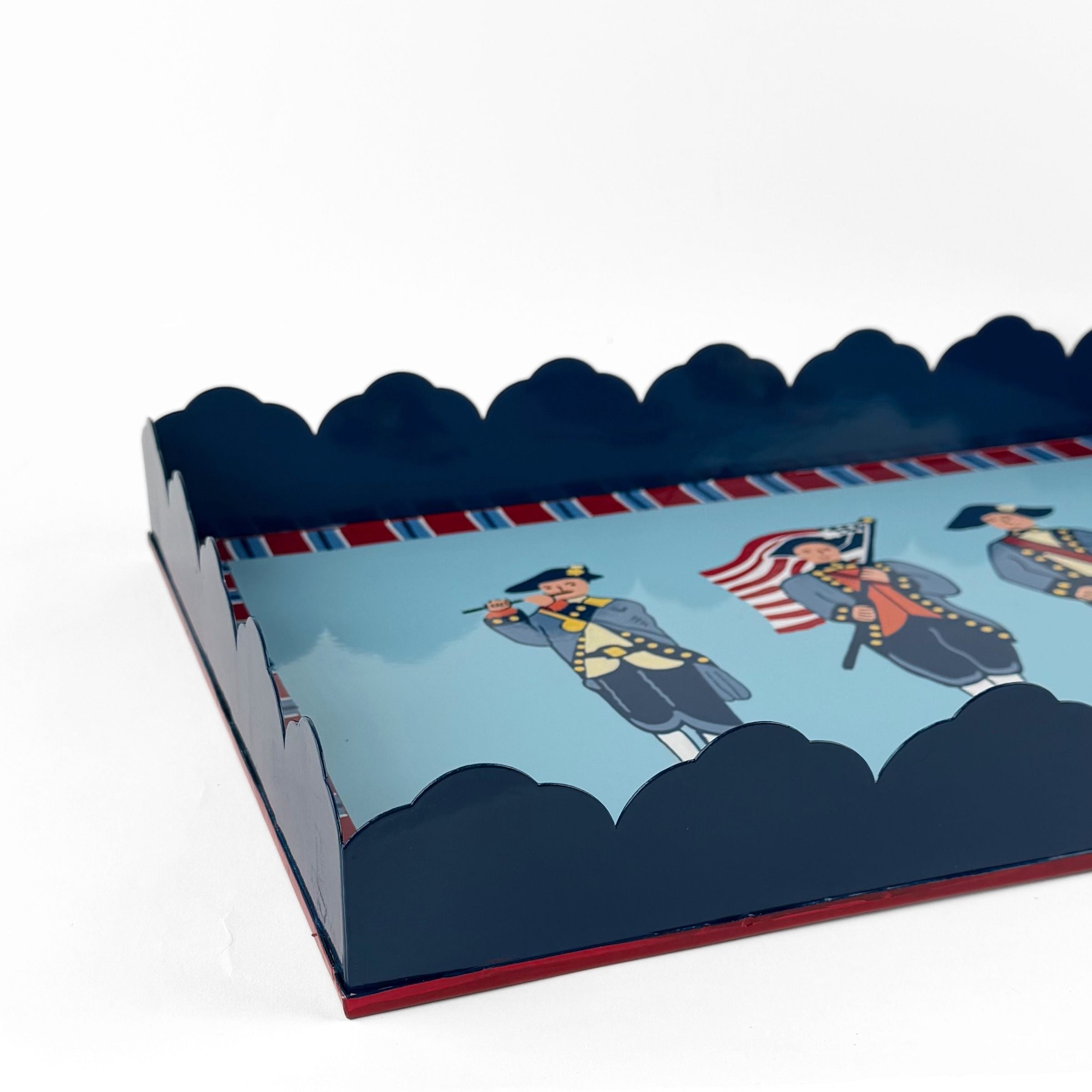 America patriotic red blue white tray closeup with scalloped navy edges and colonial soldier illustration details.