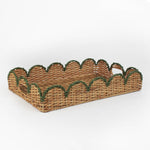 Rattan tray with scalloped edge and green trim on a white background