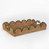 Rattan tray with scalloped edge and green trim on a white background