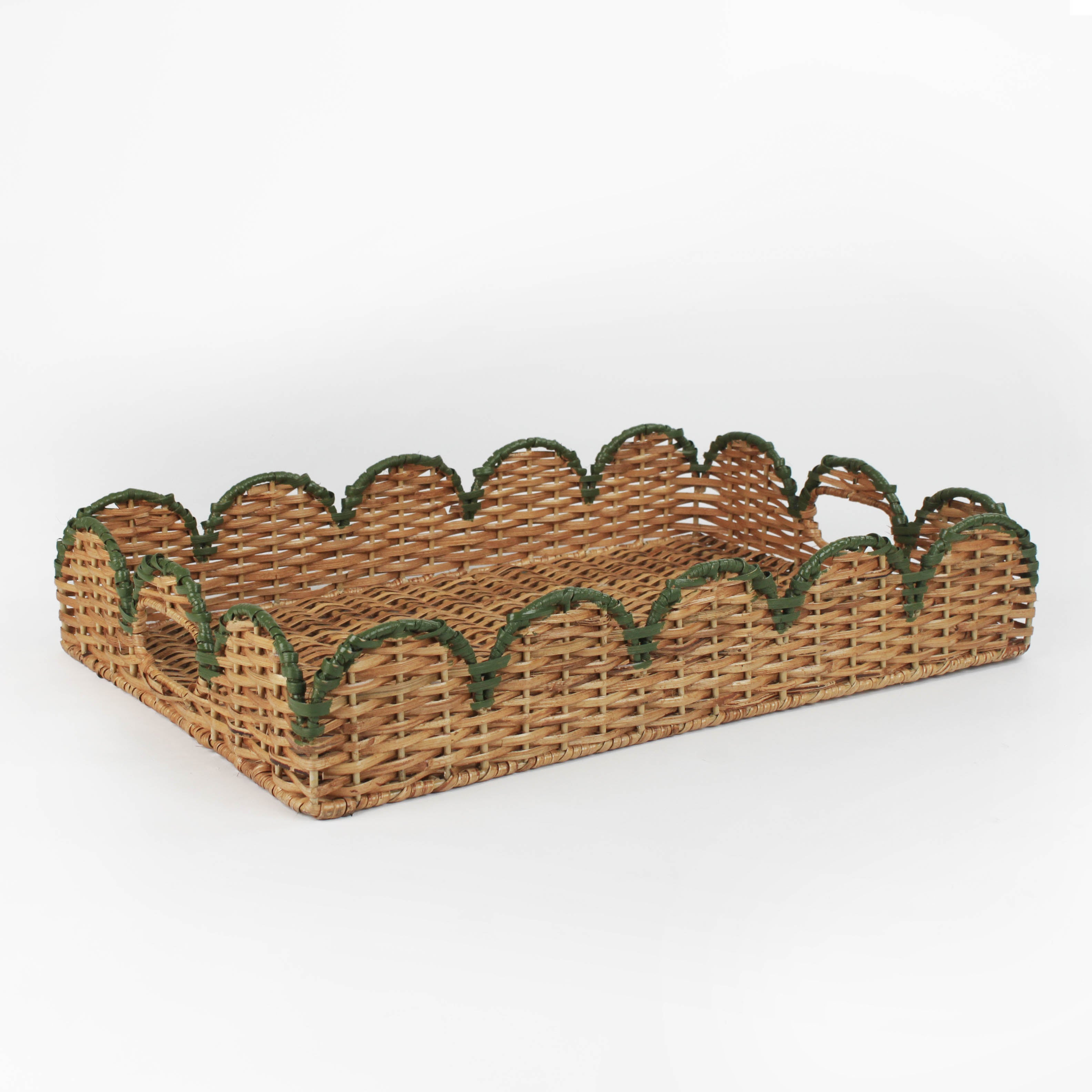 Rattan tray with scalloped edge and green trim on a white background