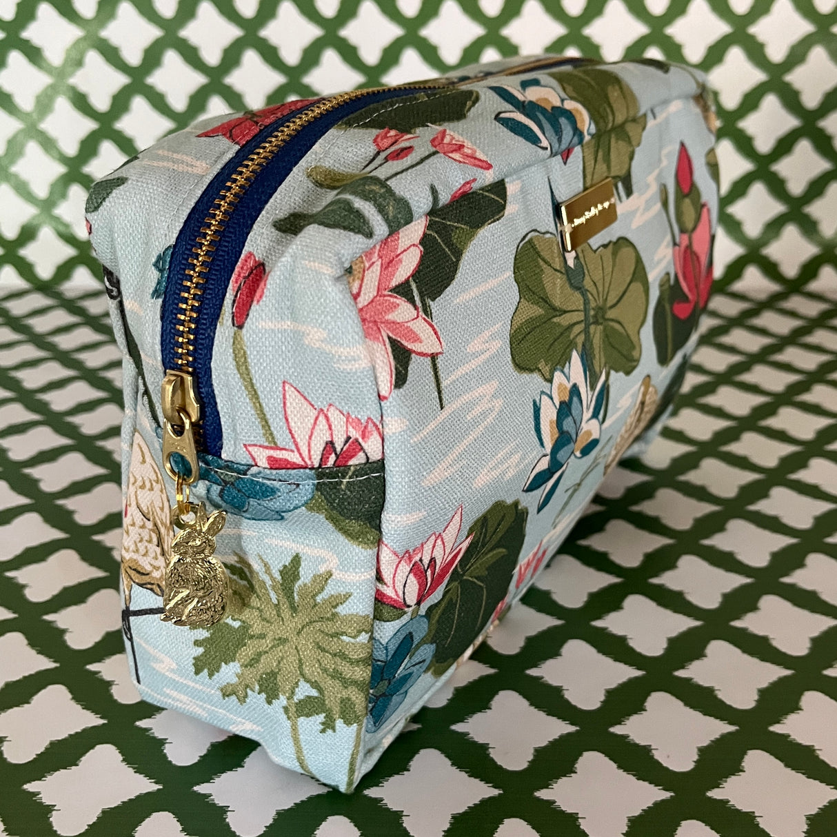 Front 3/4 view of Meadow Club toiletry bag in sky blue features a lily pond pattern