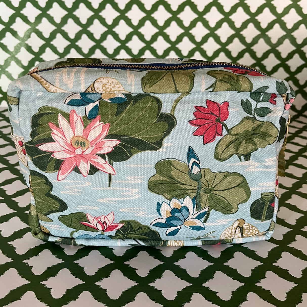 Rear view of Meadow Club toiletry bag in sky blue features a lily pond pattern