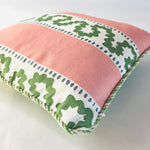 Close-up of Bahama Court striped accent pillow showing blush pink fabric, green pattern, and twisted cord trim