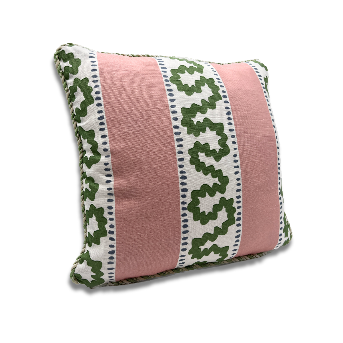 Angled view of Bahama Court striped accent pillow with blush pink panels, green pattern, and cord trim