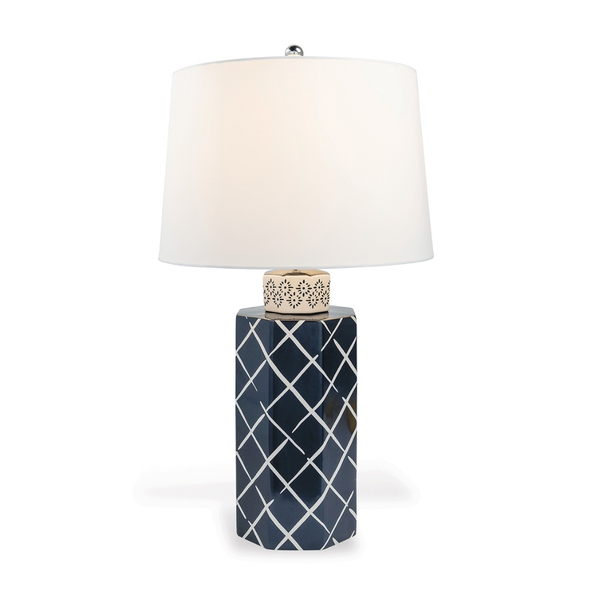 A navy blue and white table lamp with a navy blue porcelain base featuring a white lattice pattern and a plain white lampshade.