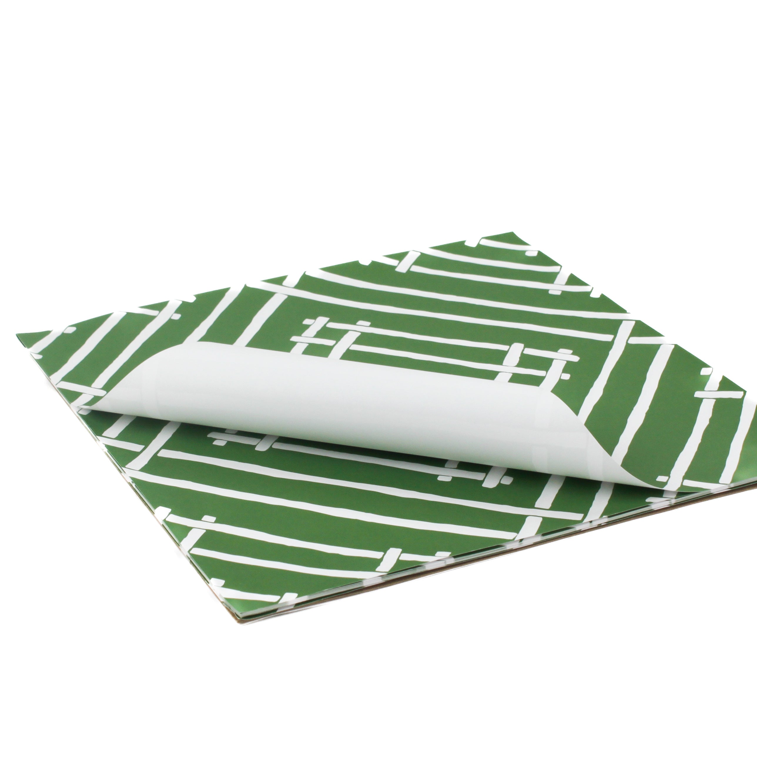 White and green paper placemats featuring a white bamboo pattern called Island House by Madcap Cottage