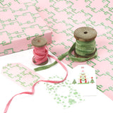 Bamboozled green and pink wrapping paper styled with ribbons and gift tags.